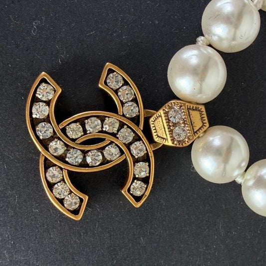 Chanel white pearl necklace with gold hardware and crystal accents
