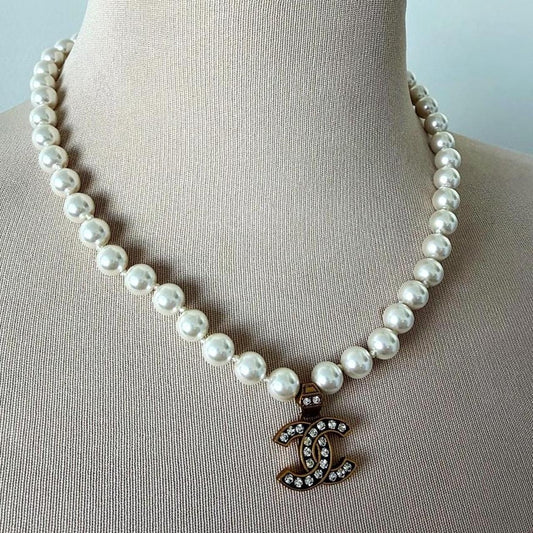 Chanel white pearl necklace with gold hardware and crystal accents