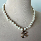 Chanel white pearl necklace with gold hardware and crystal accents